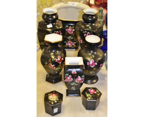 A pair of late 19th century baluster shaped mantel vases, painted and gilded  with roses on a black ground ; conforming jardi