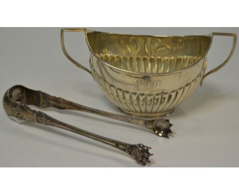 A late Victorian silver twin handled boat sugar bowl, gadrooned body, London 1899; a pair of continental sugar tongs (2)