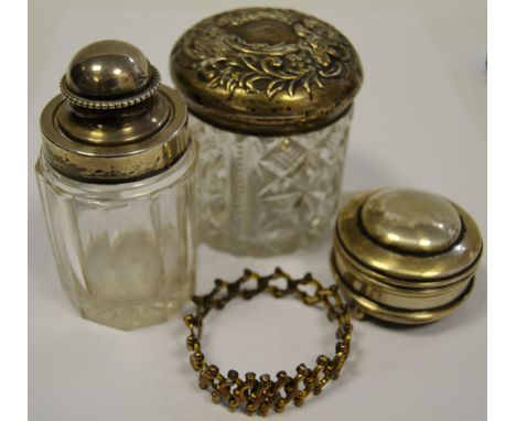 A silver mounted clear glass salts bottle, Birmingham 1905; a silver mounted dressing table jar, Birmingham 1900; a silver pi