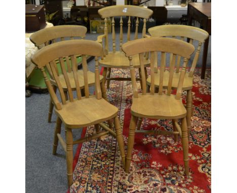 A set of four stick back kitchen chairs and a conforming carver