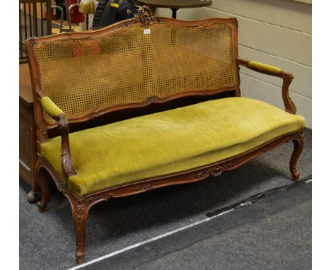 A late 19th century French walnut and bergere salon sofa, carved shell cresting rail, velvet upholstered seat c.1870