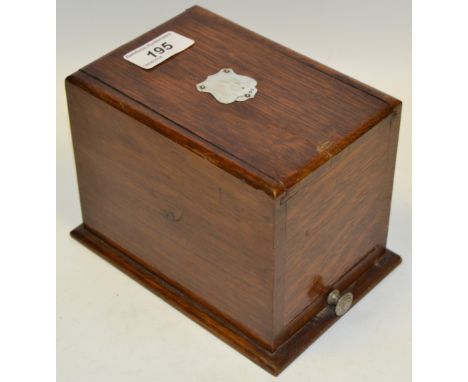 An early 20th century silver mounted oak cigarette dispenser, hopper mechanism with drawer to base, c.1920