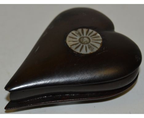A 19th century treen heart shaped snuff box, push-fitting cover inlaid with an inscribed mother of pearl roundel