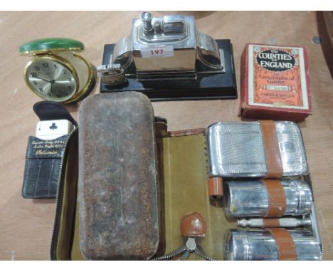 A gentlemans selection including Art Deco desk lighter and miniature, vanity set, leather boxed Rolls razor, travel clock  et