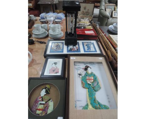 A selection of framed Oriental art and wind chime