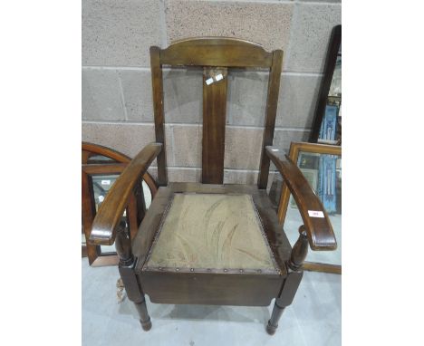 An early 20th century oak commode chair