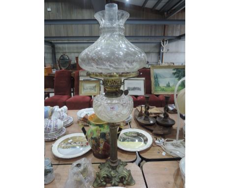 A vintage oil lamp with brass stem on gilted brass base with glass well and shade etc