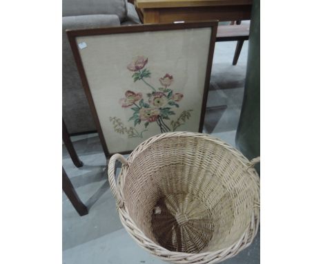 A wicker log basket and vintage embroidered firescreen