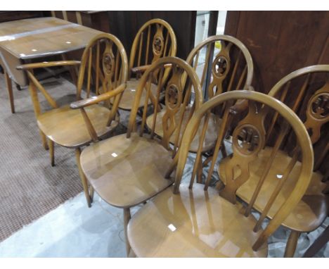 A set of 6 (4 plus 2 ) dark stained Ercol style kitchen chairs and similar drop leaf table