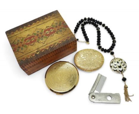 A decorative wooden box with gold plated compact marked Avon, together with a compact marked Stratton, an Art Deco style stat