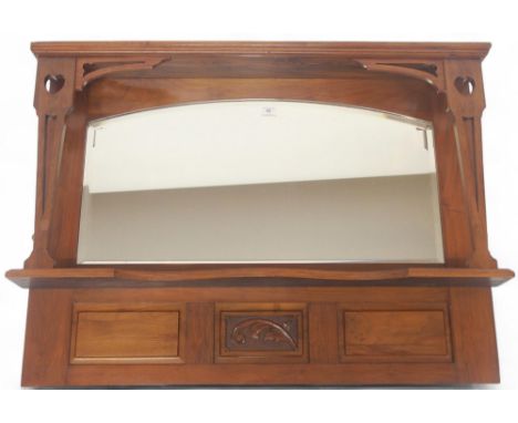 An early 20th century mahogany framed Arts &amp; Crafts overmantle mirror with arched bevelled glass mirror pane flanked by p