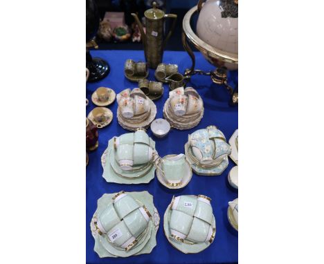 A Plant Tuscan tea set, comprising twelve cups and saucers, eleven plates, milk jug and sugar bowl, decorated with green scro