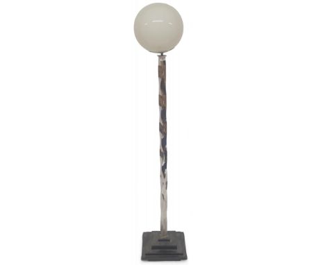 An early 20th century Art Deco style standard lamp with spherical glass shade on wavy chromed upright on stepped metallic bas
