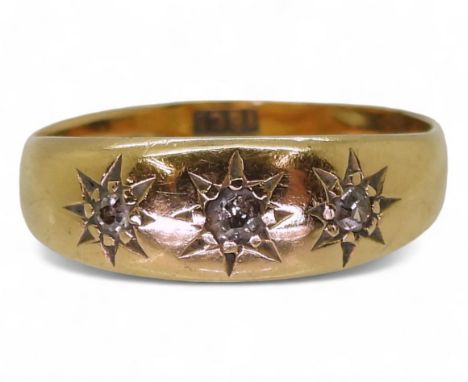 An 18ct gold three stone diamond ring, the diamonds are set in star settings, size Q1/2, weight 3.2gms&nbsp; Condition Report