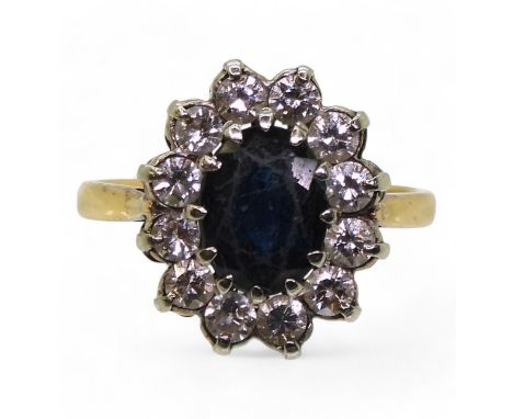 An 18ct gold sapphire and diamond classic cluster ring, set with estimated approx 0.60cts of brilliant cut diamonds, size M1/