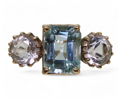 A yellow metal ring set with a step cut aquamarine and round cut clear gems,finger size approx O, weight 4.8gms&nbsp; Conditi