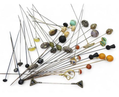 A collection of hat pins to include, a gilded Art Nouveau example set with fresh water pearls, two amazonite topped pins moun