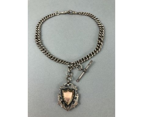 Hallmarked Silver watch chain with hallmarked Albert and a Silver medallion in the shape of a shield with Gold Coloured Carto