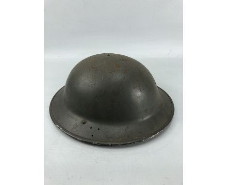 Military tin Brodie helmet with original webbing and black liner