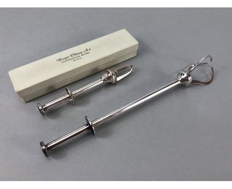 Two pairs of Silver coloured sprung sugar nips the smaller boxed and marked for Birger Olberg Oslo and marked 880, both with 