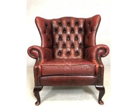Vintage red leather wingback armchair (A/F)