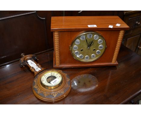 An Edwardian carved walnut wall hanging barometer/thermometer, arched top, carved case; Russian Jantos ting tang chiming mant