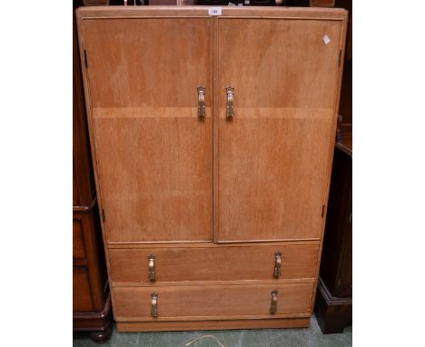 A light oak tallboy by Shrager Furniture, two door cupboard over two long drawers. 123cm high x 84cm wide x 47cm deep.