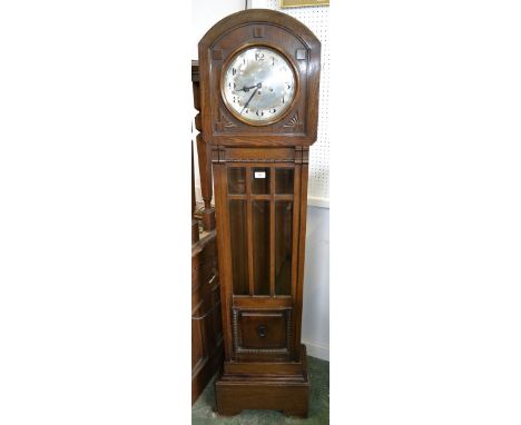 An oak longcase clock, domed top, glass panelled door