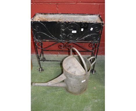 A wrought iron planter; a zinced watering can (2)