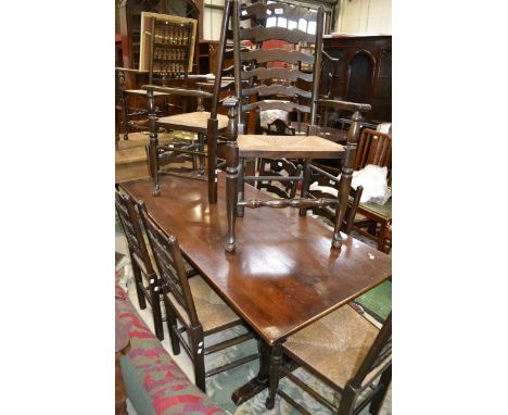 An oak refectory style table, rounded rectangular top, lyre shaped supports; six rush seated ladder back dining chairs; two c