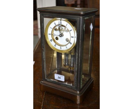 A late 19th century lacquered brass mantel clock, Roman numerals, mercury pendulum