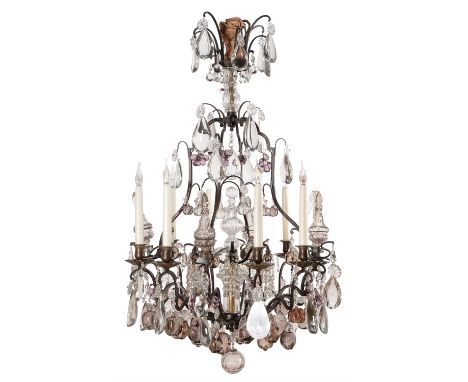 A French patinated metal and clear and tinted glass hung eight branch chandelier, in Louis XV style, first half 20th century,