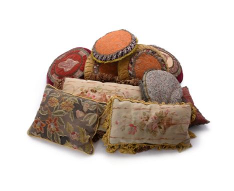 A group of eleven cushions, comprising; two pairs of similar velvet and braid applied circular cushions, each 38cm diameter, 