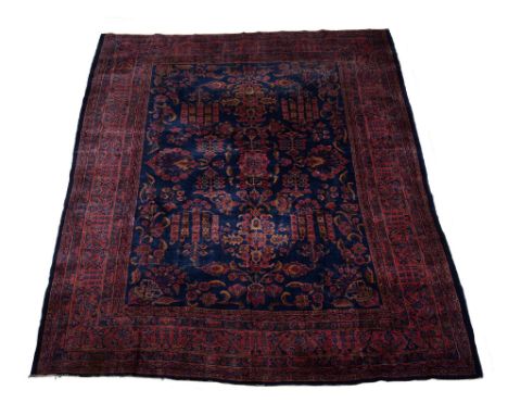 A Mohajeran carpet, the blue field decorated with flowering foliage in tones of ochre and puce , within floral borders and gu