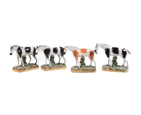 A group of similar Staffordshire pottery models of three piebald horses and one skewbald horse of William Kent Ltd. type, fir