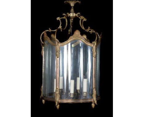 A brass and glazed hall lantern in George III style, of recent manufacture, the bowed frame cast with shells and scrolls, and