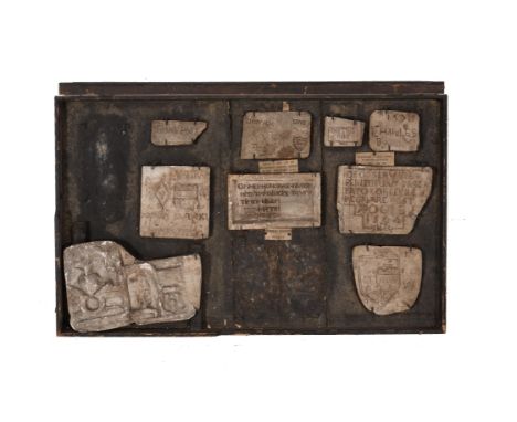 A framed collection of plaster casts of Early Modern printing blocks, early 20th century, after 16th century originals in Eng