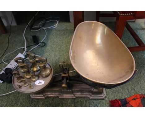 A Large Cast Iron Kitchen scales with detachable shaped brass pan and a set of Brass baluster weights 