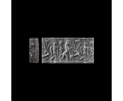 2nd millennium BC. A carved rhyolite cylinder seal with intaglio stag, eagle, rearing ram(?) and objects in the field.   6.64