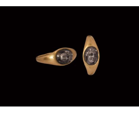 2nd century AD. A gold finger ring with inset silver face of Venus modelled in high relief.   3.73 grams, 19.16mm overall, 12