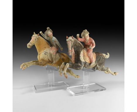 Tang Dynasty, 618-906 AD. A dynamic pair of ceramic polo-player figures, each a galloping horse with legs extended and mane f