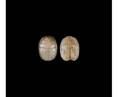 Persian Period, 7th century BC. A chalcedony scarab with intaglio scene to the underside, median date palm with fruit flanked