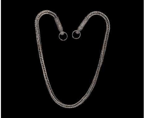 10th-12th century AD. A substantial silver necklace of looped links, D-section beast-head terminals with elaborate filigree d