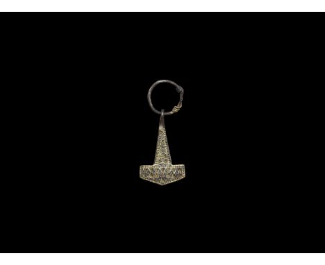 10th-11th century AD. A silver-gilt hammer pendant with ring, punched pellet and triangle ornament.   9 grams, 59mm (2 1/4").