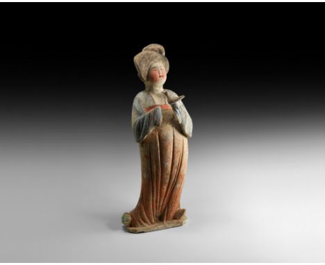 Tang Dynasty, 618-906 AD. A finely modelled hollow ceramic figurine of a courtly lady with dressed hair and draped robe, arms