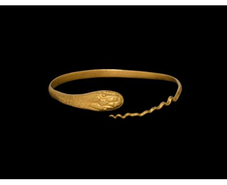 30 BC-323 AD. A D-section penannular serpent bracelet with scale detailing, undulating tail, D-shaped head with pellet eyes a