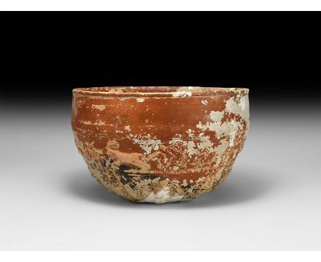 2nd-4th century AD. A ceramic redware bowl with decorative band below the rim, frieze with hounds and fleeing deer, winged an