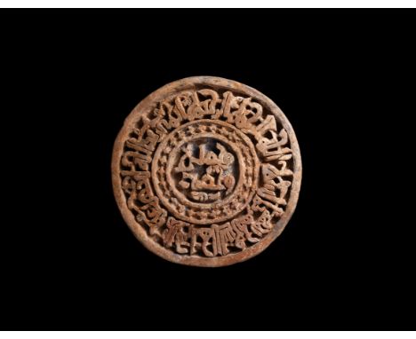 18th-19th century AD. A substantial circular ceramic wall tile with raised rim and inner ring of crosses, band of raised Kufi