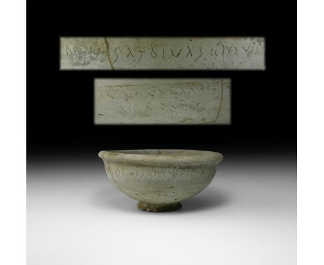 1st-2nd century AD. A ceramic footed bowl with rounded rim, incised line to the equator, cursive inscription which is a simpl