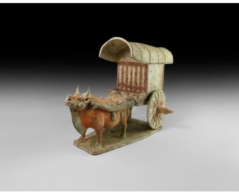 Tang Dynasty, 618-906 AD. A finely modelled ceramic model oxcart on a rectangular base, the beast with harness and yoke decor